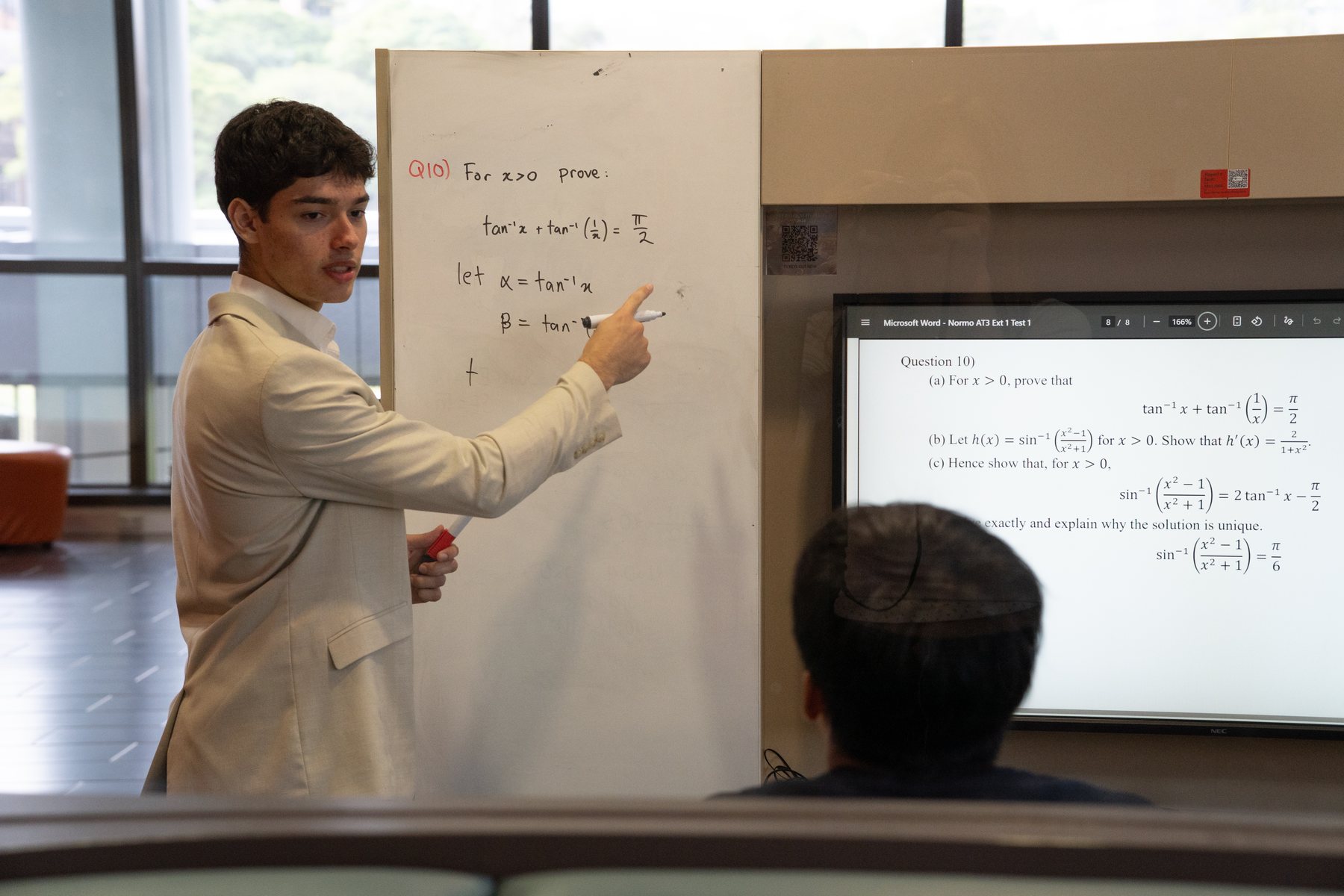 Koren Academy tutor teaching Maths at the board